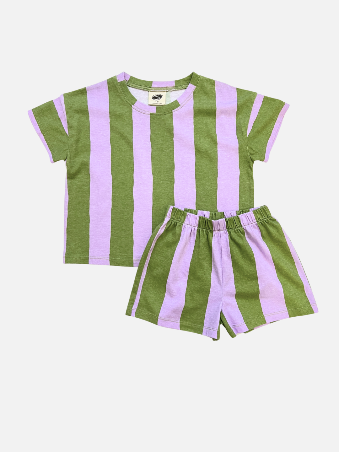 The UMBRELLA STRIPE SHORT SET in Green/Purple is a unisex set with a soft organic cotton t-shirt and shorts, both featuring wide vertical stripes. This matching play set is shown on a plain white background.