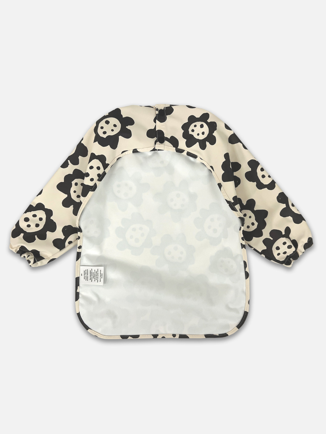 Black Sunflowers | Back view of the long sleeve cream colored bib with black sunflowers and a back cut out with two buttons for closure.