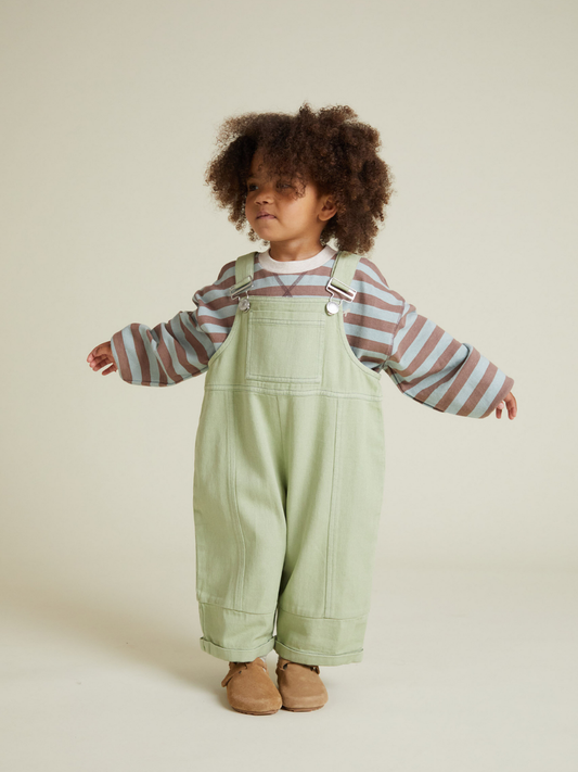 Second image of BLYTHE MINT DUNGAREE: Light green toddler overalls with adjustable shoulder straps, a front pocket, and rolled cuffs shown on a plain white background.