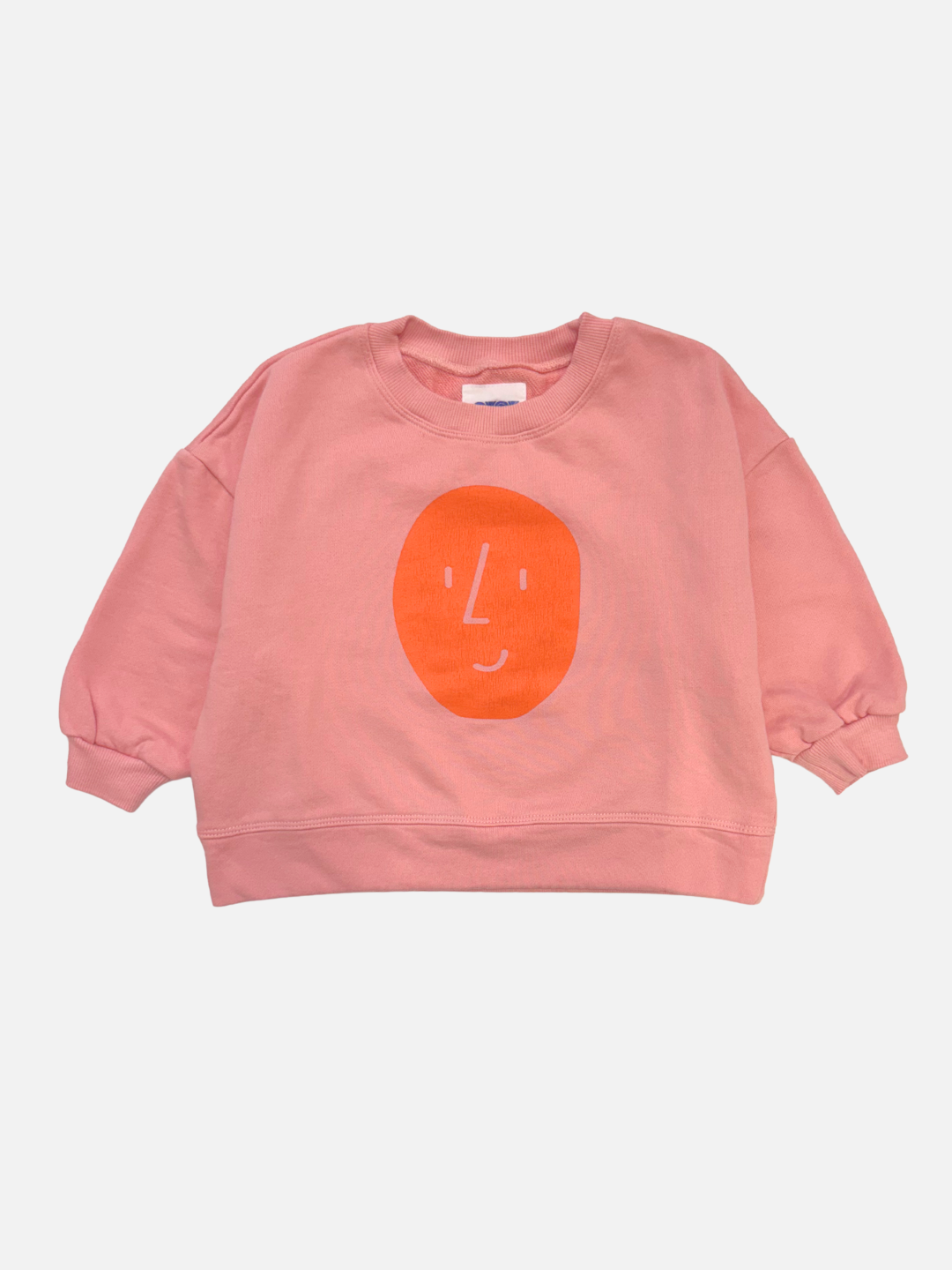 A pink BOXY POTATO SWEATSHIRT by OXOX CLUB, made from organic cotton, features a simple orange face graphic on the front and is displayed laid flat on a white background.