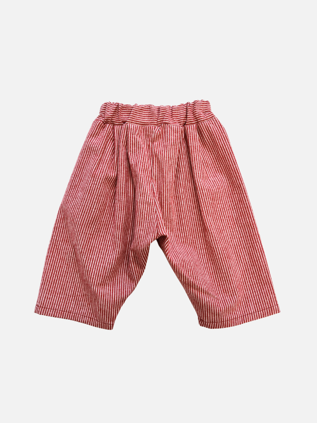 Red | The SOFT STRIPE BABY PANT features loose-fitting red and white vertical stripes with an elastic waistband, shown against a white background.