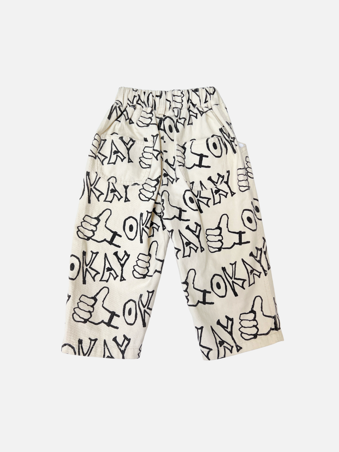 Ecru | OKAY JEANS: White relaxed-fit jeans with an all-over black "OKAY" text and hand gesture print, shown flat on a white background.