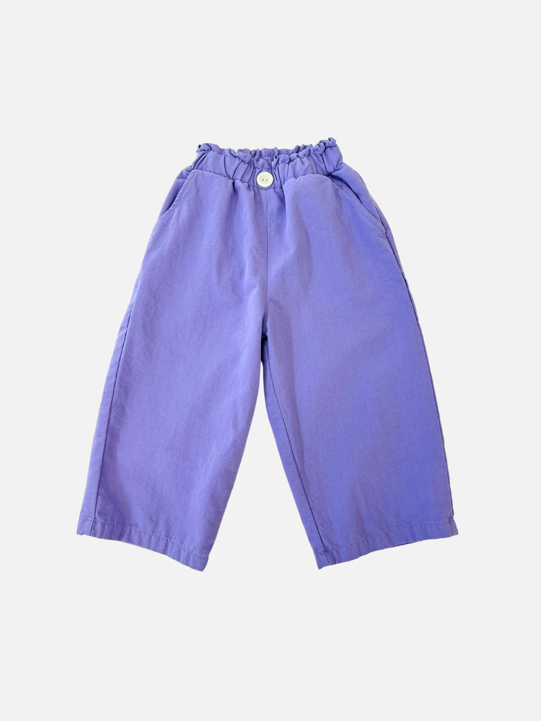 Purple | The JELLY PANTS are purple wide-leg pants made from woven cotton, featuring an elastic waistband and a white button, presented against a white background. These relaxed pull-on pants reflect the trendy style of Korean kids' brands.