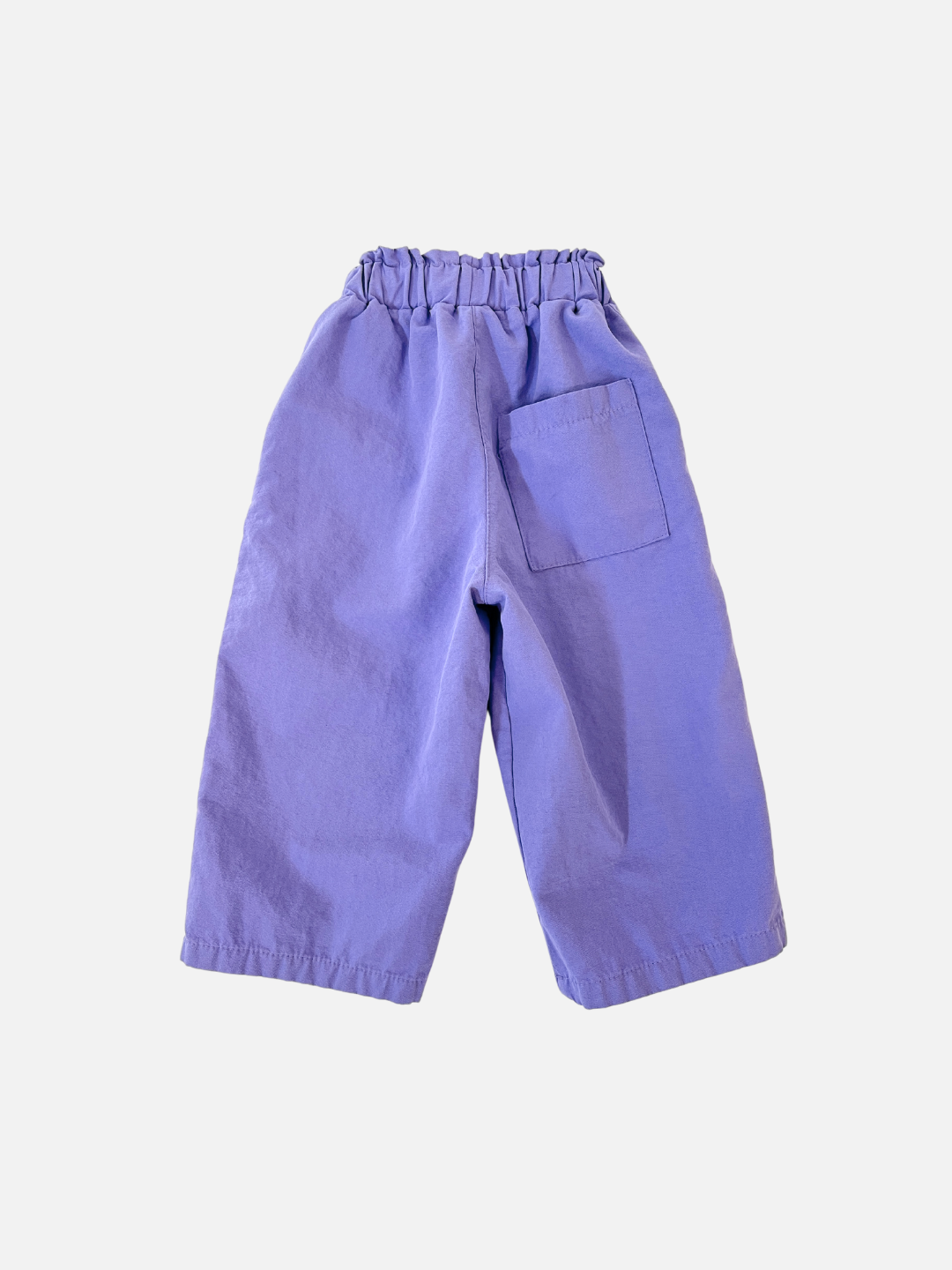 Purple | The JELLY PANTS by a trendy Korean kids brand are relaxed pull-on pants in vibrant purple, featuring an elastic waistband and a single back pocket, made from soft woven cotton. Perfectly styled against a plain white background.