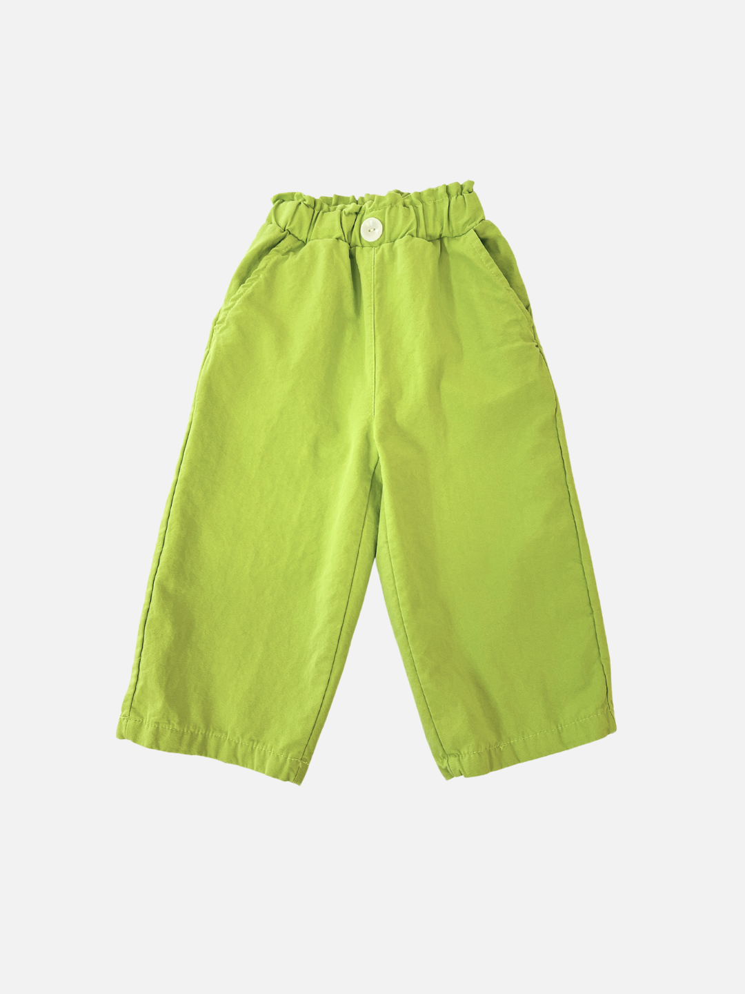 Green | The JELLY PANTS, from a Korean kids brand, are bright green with a relaxed pull-on style, featuring an elastic waist and large button. Crafted from woven cotton, they have two side pockets and wide legs, beautifully displayed against a white background.
