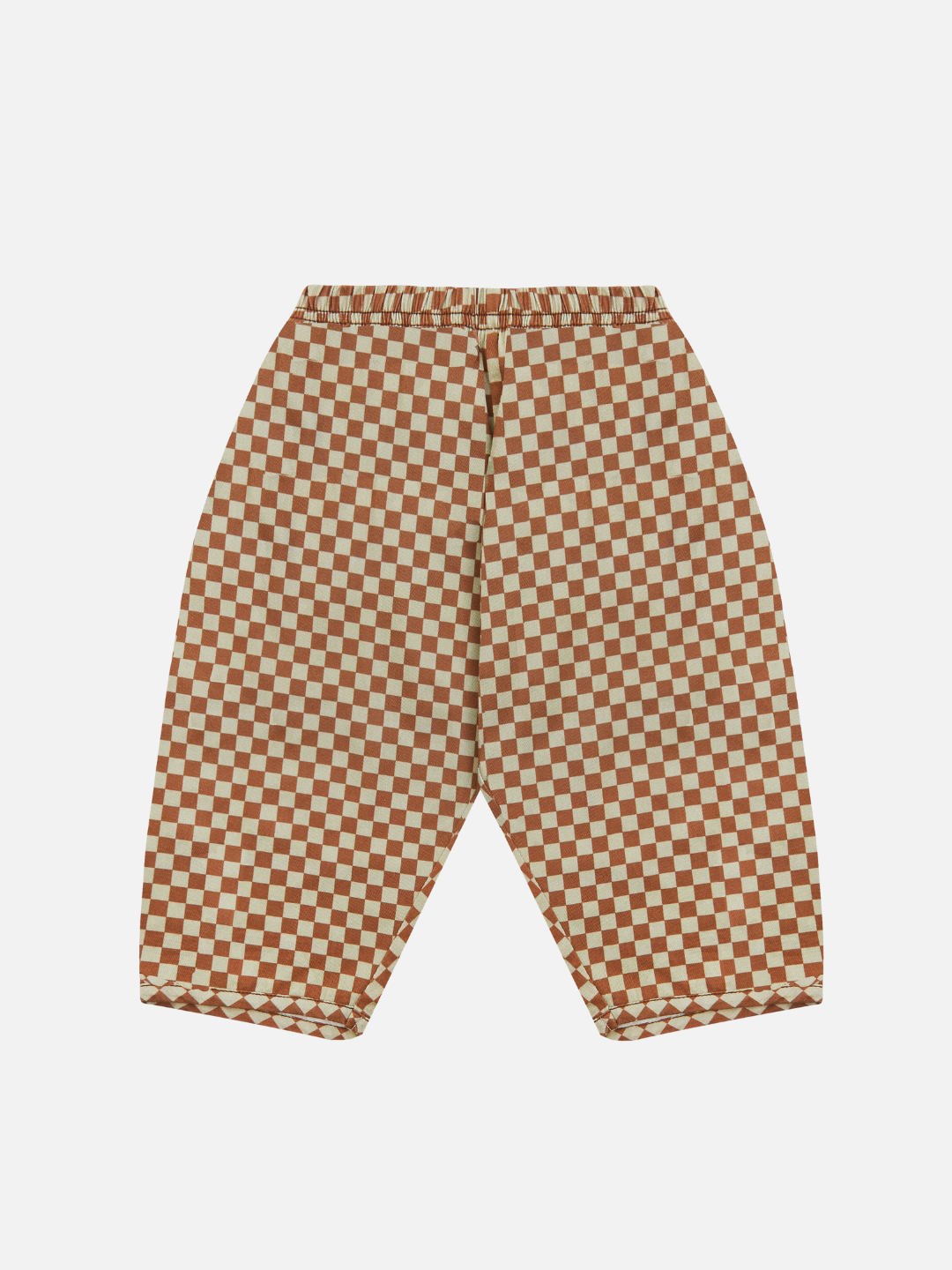 The BRICK CHECK TROUSER is a pair of unisex pants featuring a bold red and white checkered pattern, crafted from organic cotton twill. Designed with an elastic waistband and slightly tapered leg for both comfort and style, these pants are made using eco-friendly dyes, making them as sustainable as they are stylish.