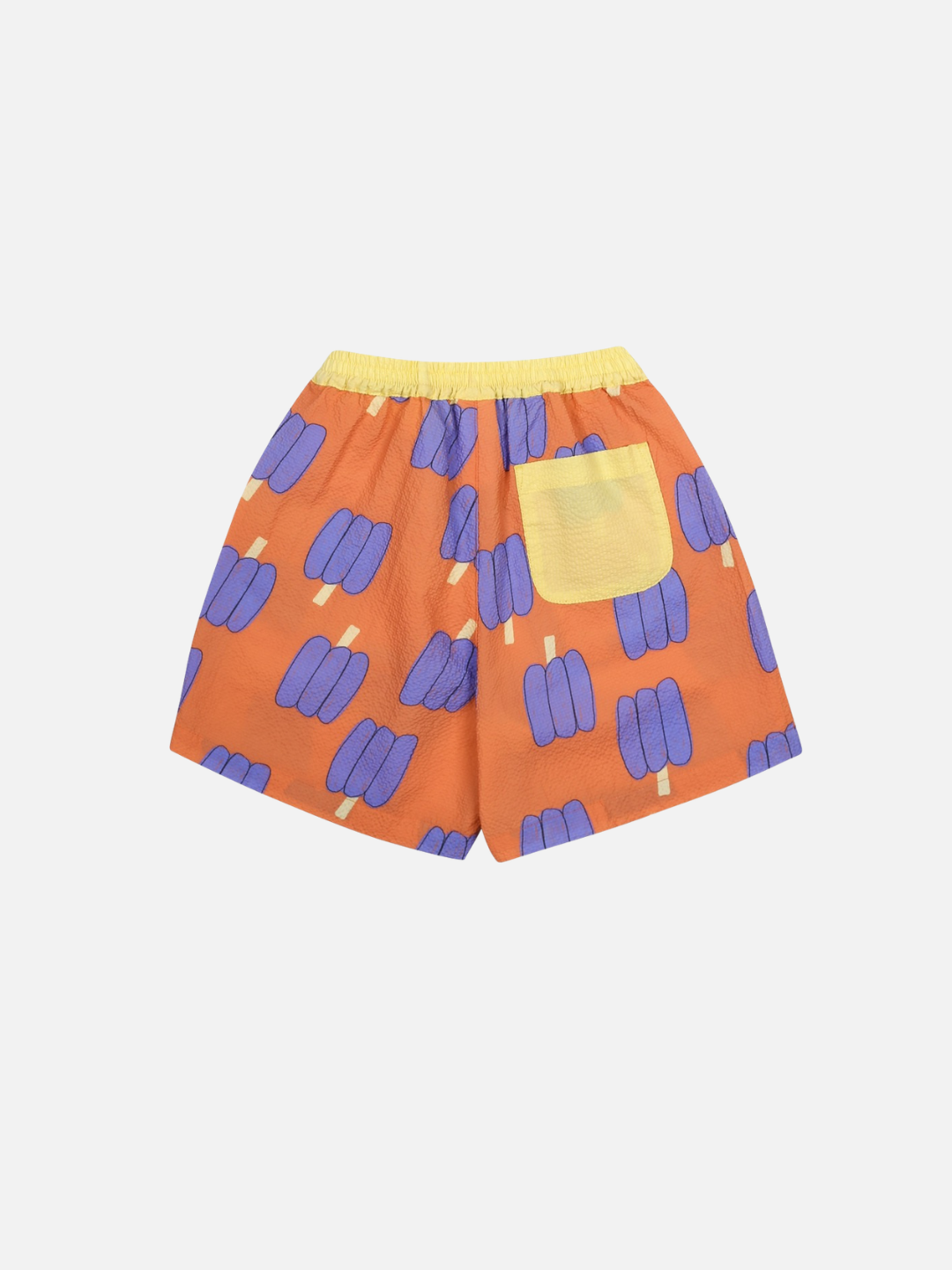 Orange shorts with purple bell pepper pattern on a light gray background