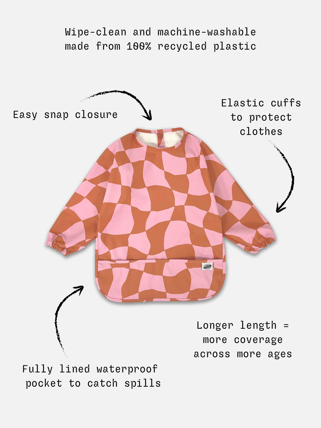 Pink Checkers | Detailed information of the long sleeve light pink and rust wavy checked bib with a front pocket.