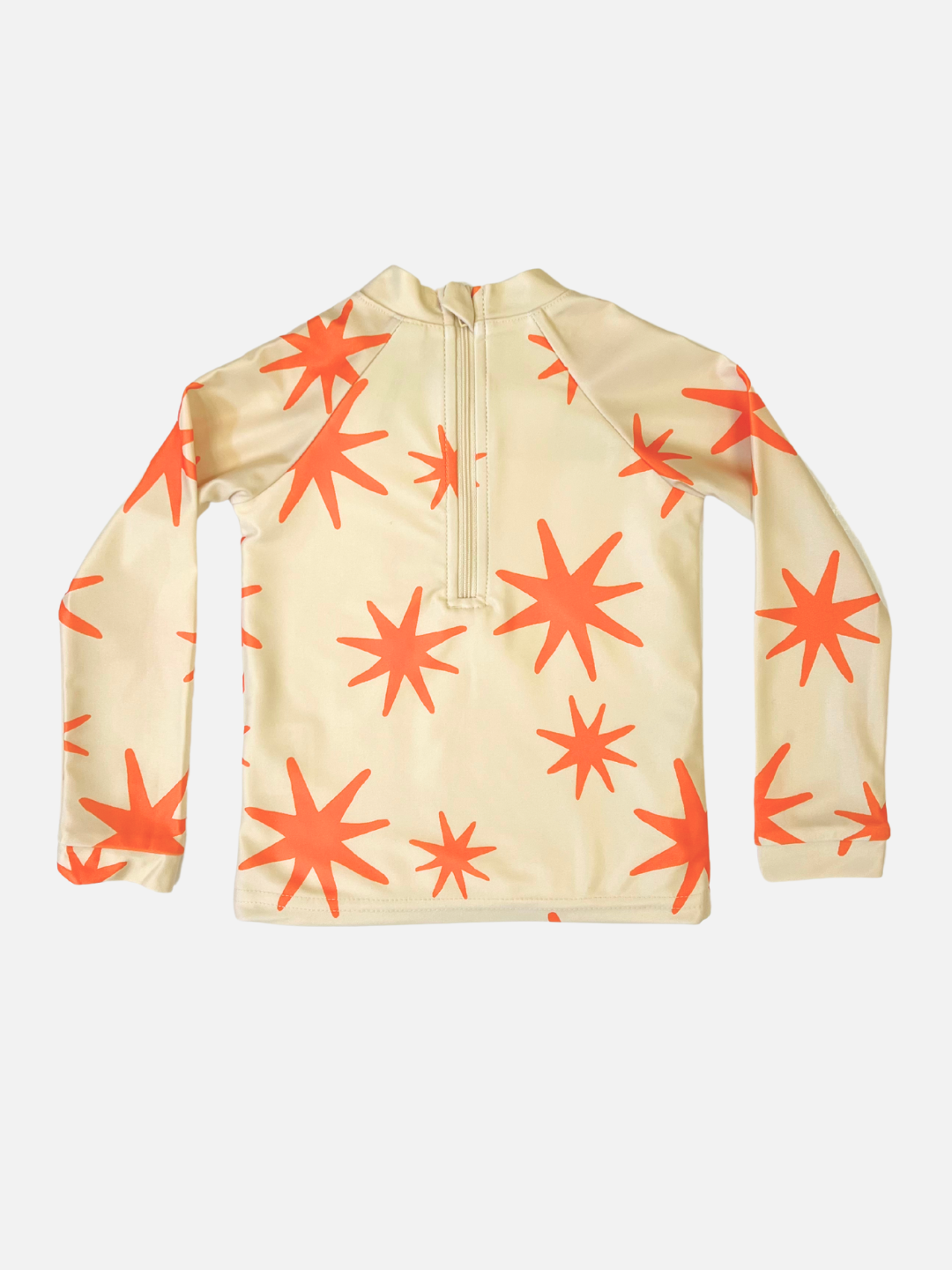 Capri | Laid flat on a white background, this SWIM RASHIE is beige with bold orange star patterns, crafted from recycled fabric and featuring a back zipper.