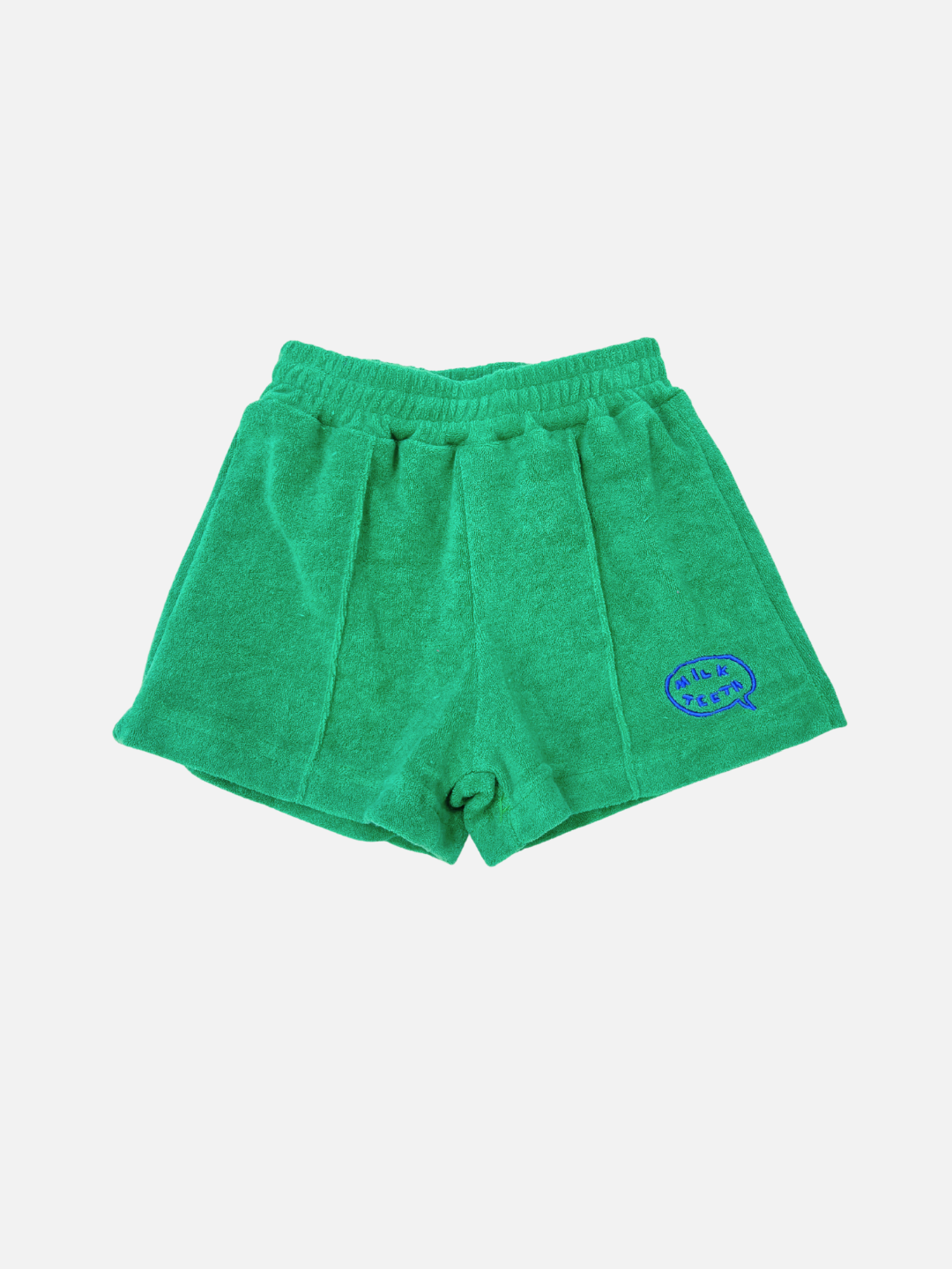 EVERYDAY TERRY SHORTS in green cotton terry, featuring an elastic waist and a blue embroidered logo patch on the lower right leg, shown against a plain white background.