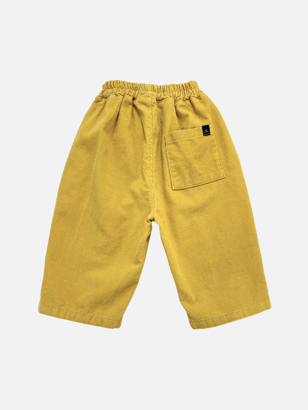 CORDUROY PANEL PANT: Yellow cotton corduroy pants from a Korean kids brand with an elastic waistband and single back pocket—perfect for Fall, shown against a white background.