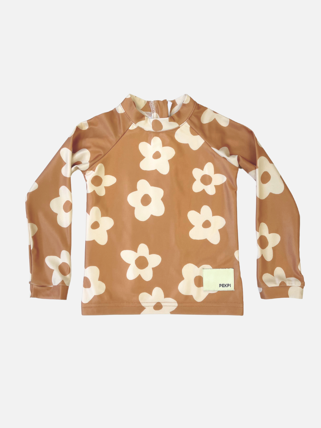 Posy | The SWIM RASHIE in Posy is a brown long-sleeve rash guard with a white floral pattern, made from Oeko-Tex certified recycled fabric and featuring a small rectangular label near the bottom hem.