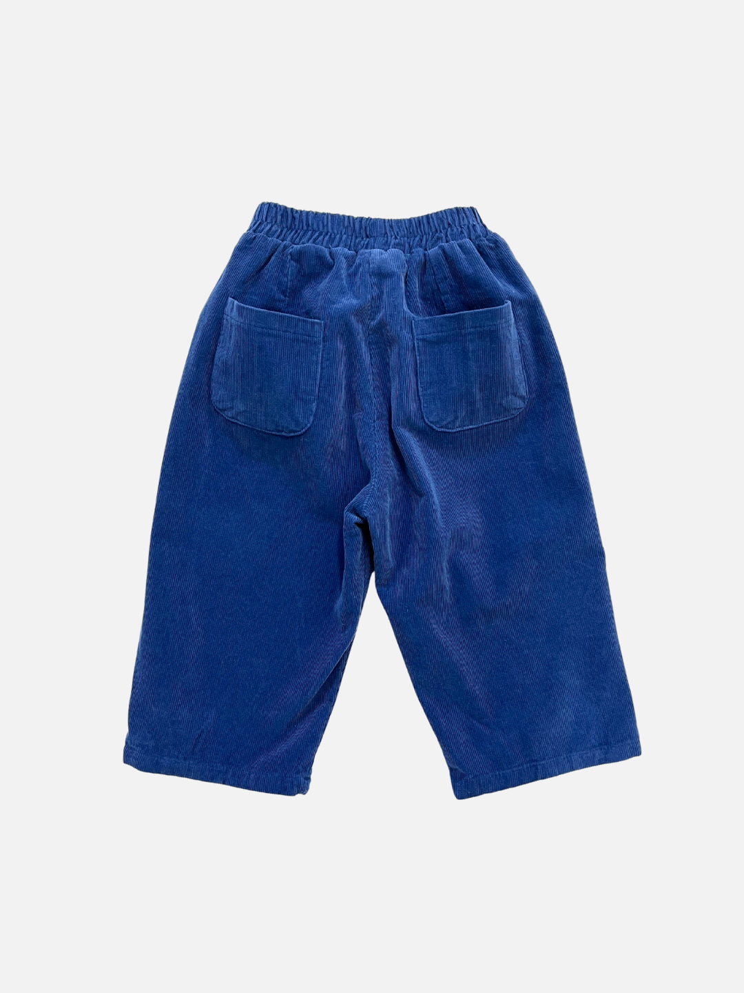 SIMPLE CORDUROY PANTS in blue cotton with an elastic waist and two back patch pockets from a trendy Korean kids brand, shown laid flat on a white background.