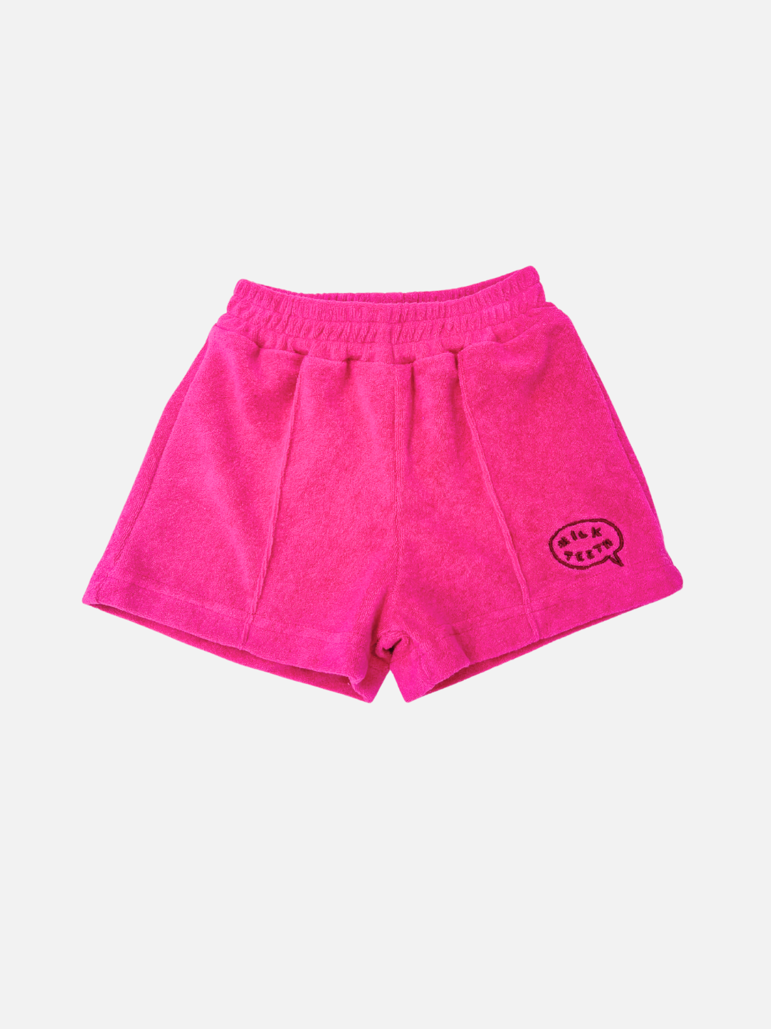 EVERYDAY TERRY SHORTS in bright pink cotton terry with an elastic waist and a small embroidered speech bubble patch on the left leg.