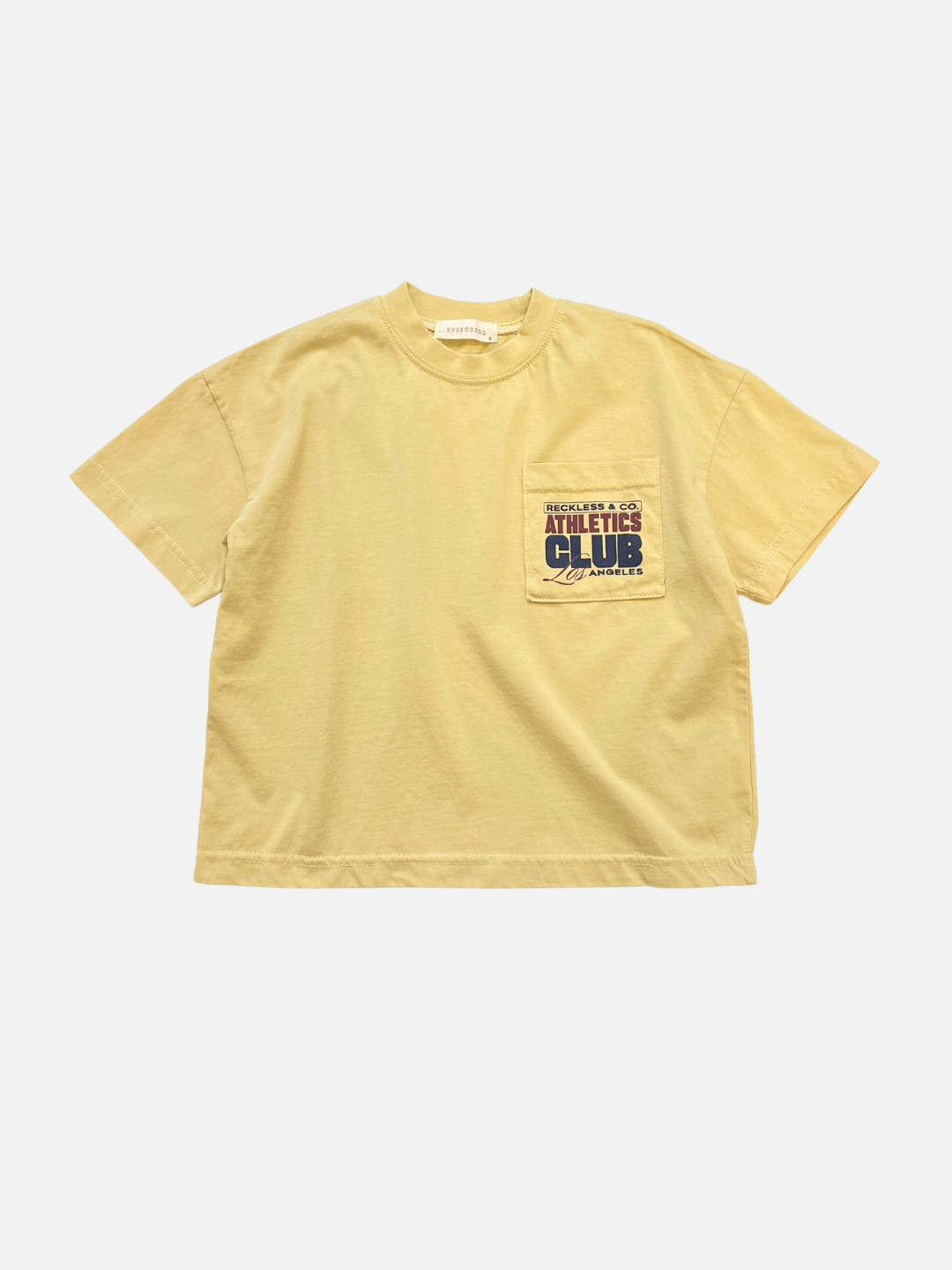 The CLUB POCKET TEE is a yellow cotton short-sleeve t-shirt with a left chest pocket and "Athletes Club" graphic, offering an oversized fit inspired by trending Korean kids brands.