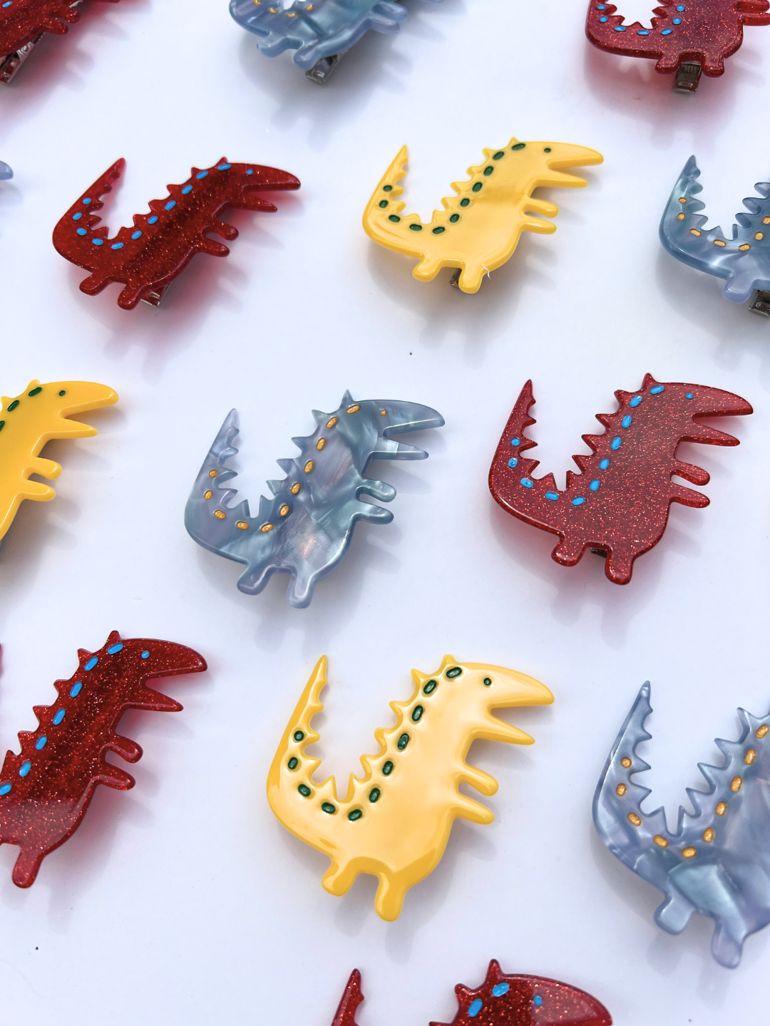 Yellow Multi | Several kids' barrettes in yellow, red, and blue, laid on table