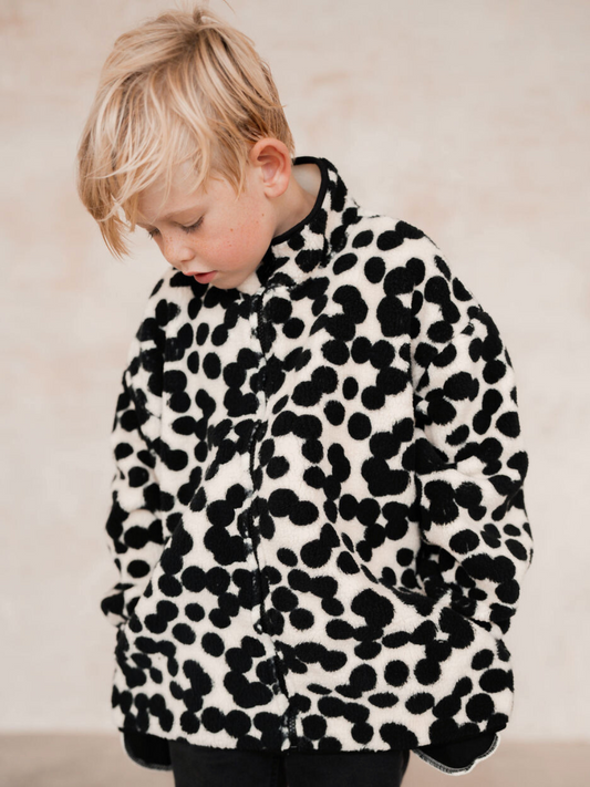 Second image of Check out the SPOT FUNNEL COAT, a cozy black and white polka dot fleece jacket featuring a high collar and long sleeves. Displayed on a plain background, this adorable piece is perfect for babies and new arrivals, ideal for keeping them warm on chilly days. Don't forget to check the price when you shop all clothing on our site!