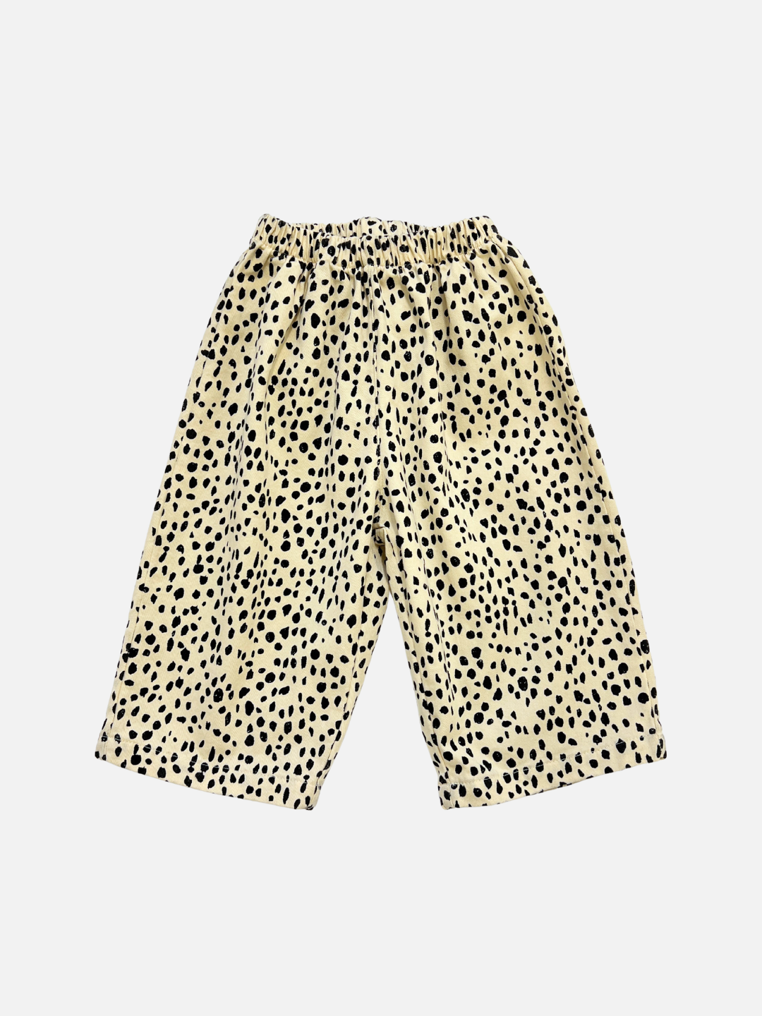 Off-White | The MINI CHEETAH SPOT PANTS are wide-legged, unisex kids' pants made from soft cotton twill with an elastic waist and a beige base featuring irregular black spots for a stylish animal print look.