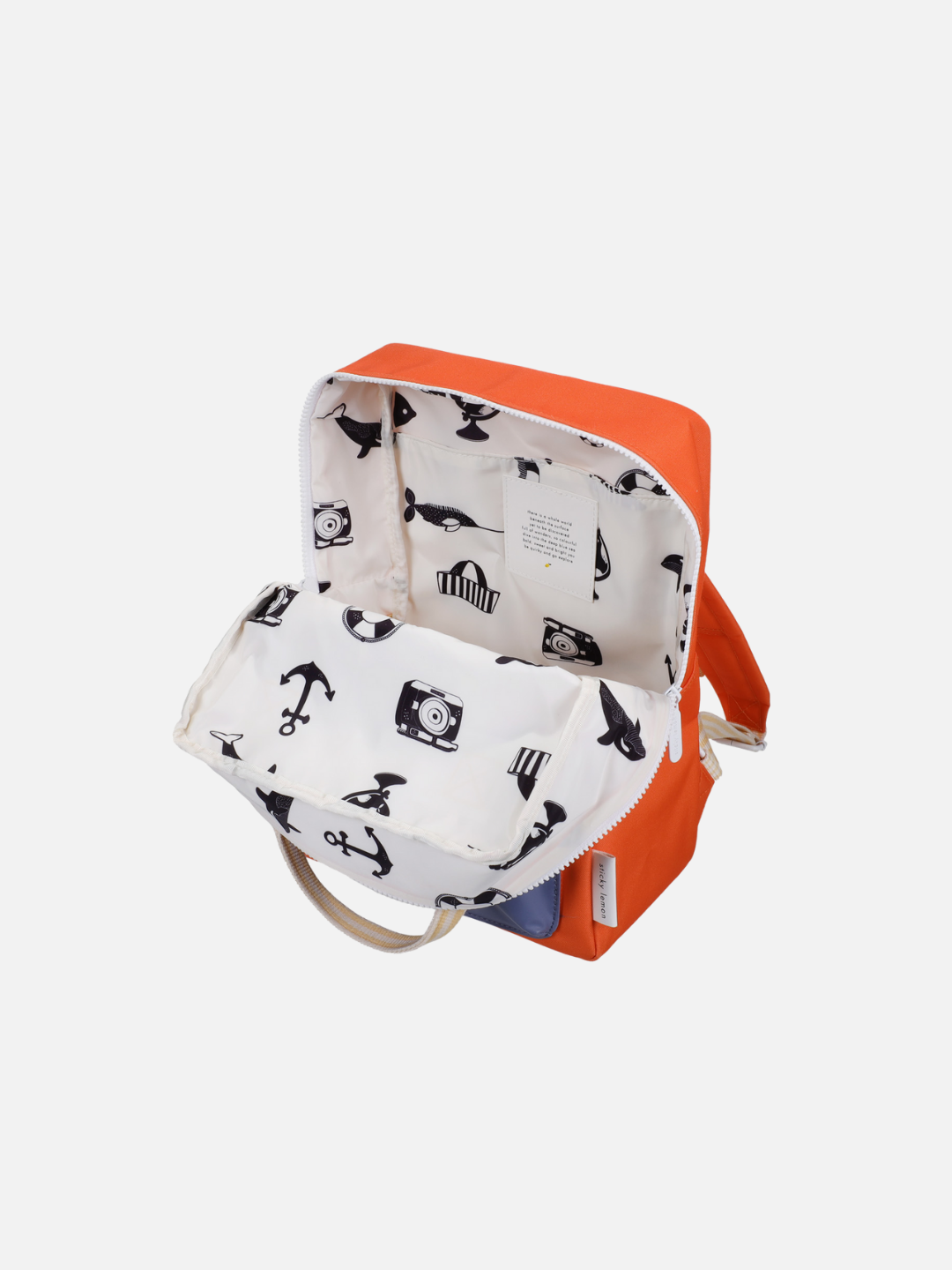 The MEDIUM ENVELOPE BACKPACK is an open, orange, medium-sized bag made from recycled materials, with a waterproof white interior lining decorated with black nautical and camera-themed illustrations, showing the main compartment and handle.