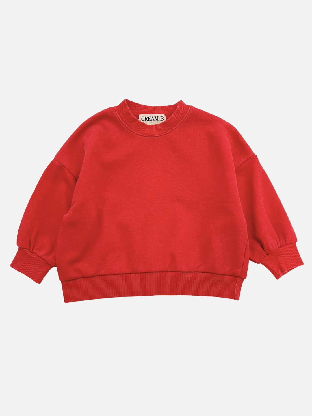The SIMPLE SWEATSHIRT in Vintage Red is a crewneck made from soft French terry cotton, with long sleeves and ribbed cuffs, shown laid flat on a white background.