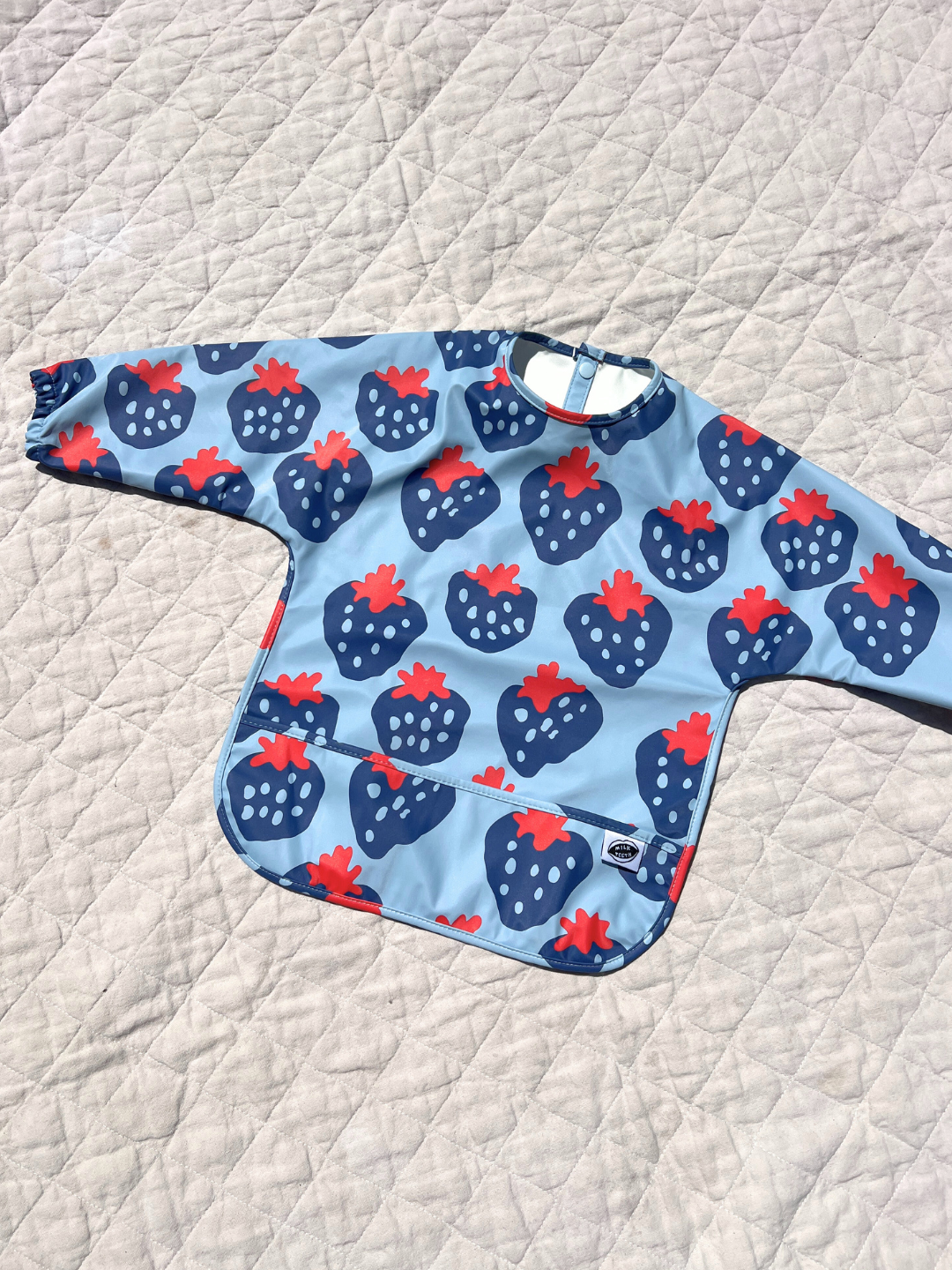 Front view of the bib laid flat on the quilt
