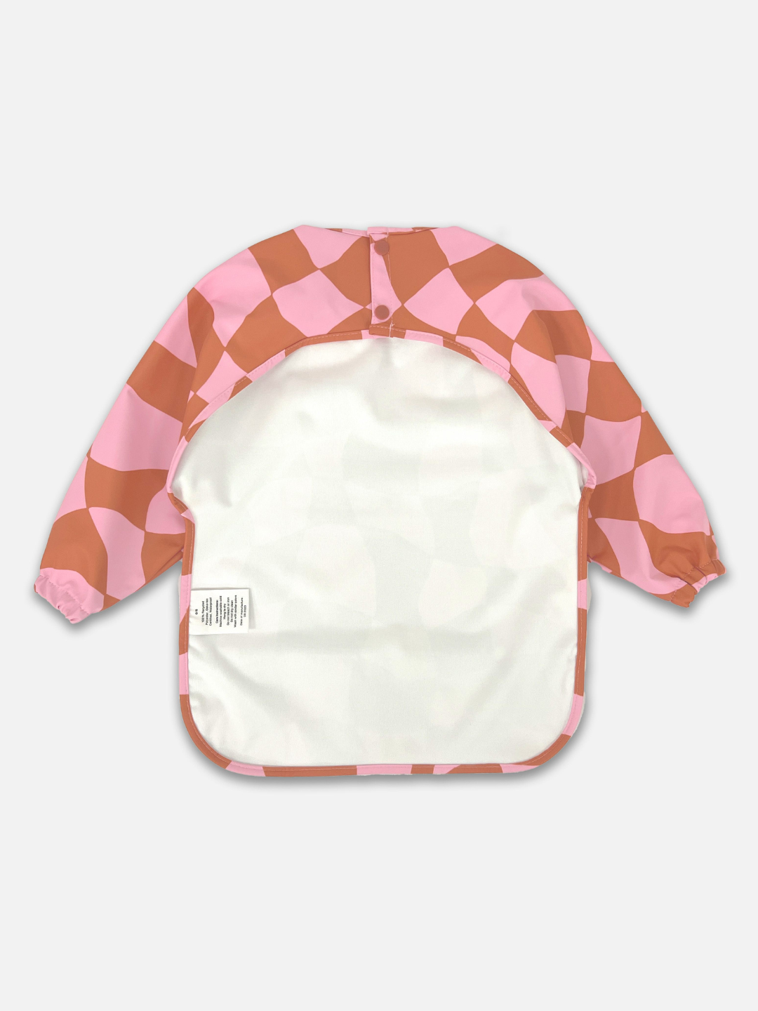 Pink Checkers | The back view of the long sleeve light pink and rust wavy checked bib with a back cut out and two buttons for closure.