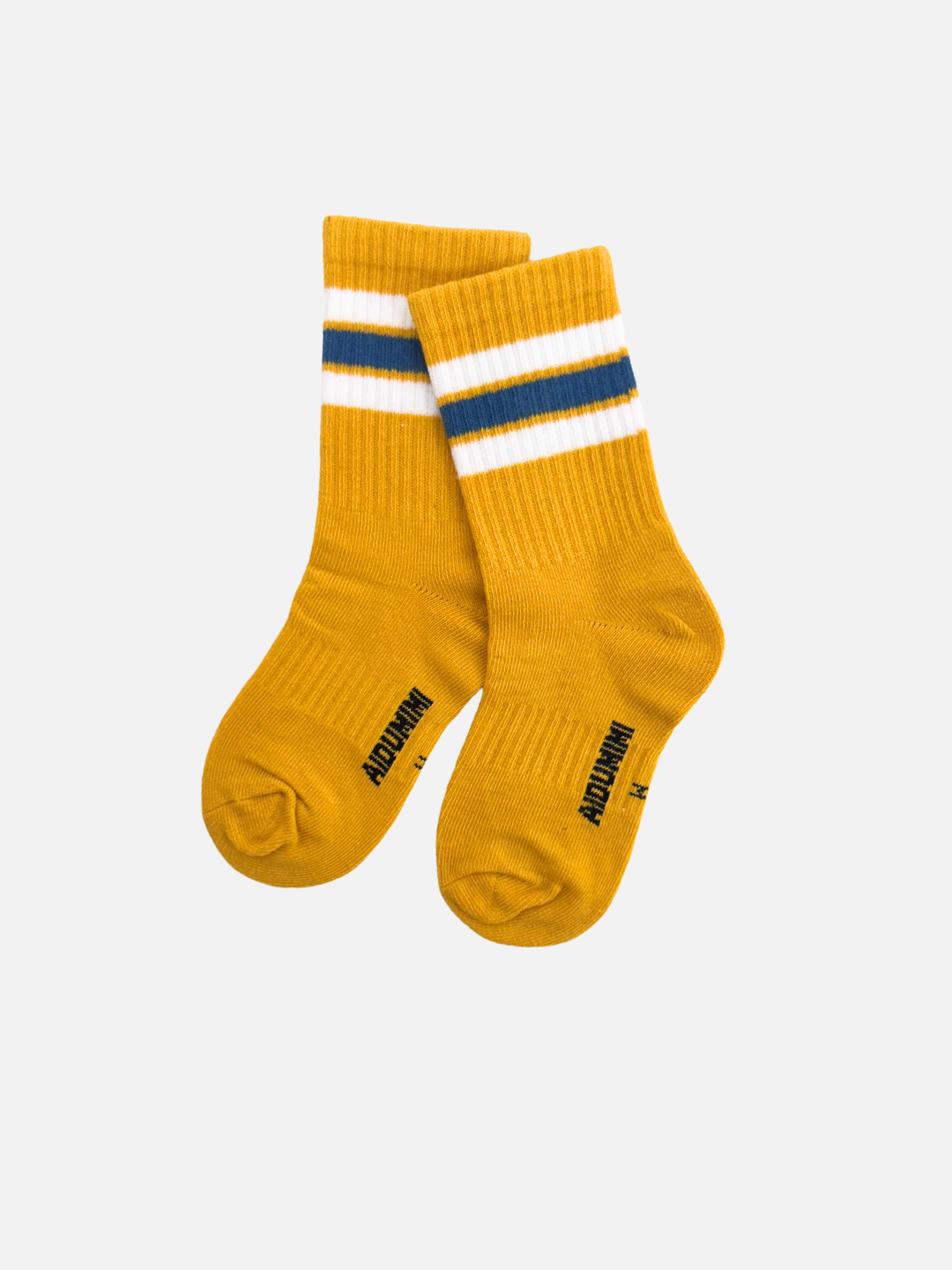 Mustard | The RETRO SOCKS are lightweight and stretchy, featuring a ribbed design with white and navy stripes near the top. The vibrant yellow hue and sporty stripes add vintage charm. Block text on instep.