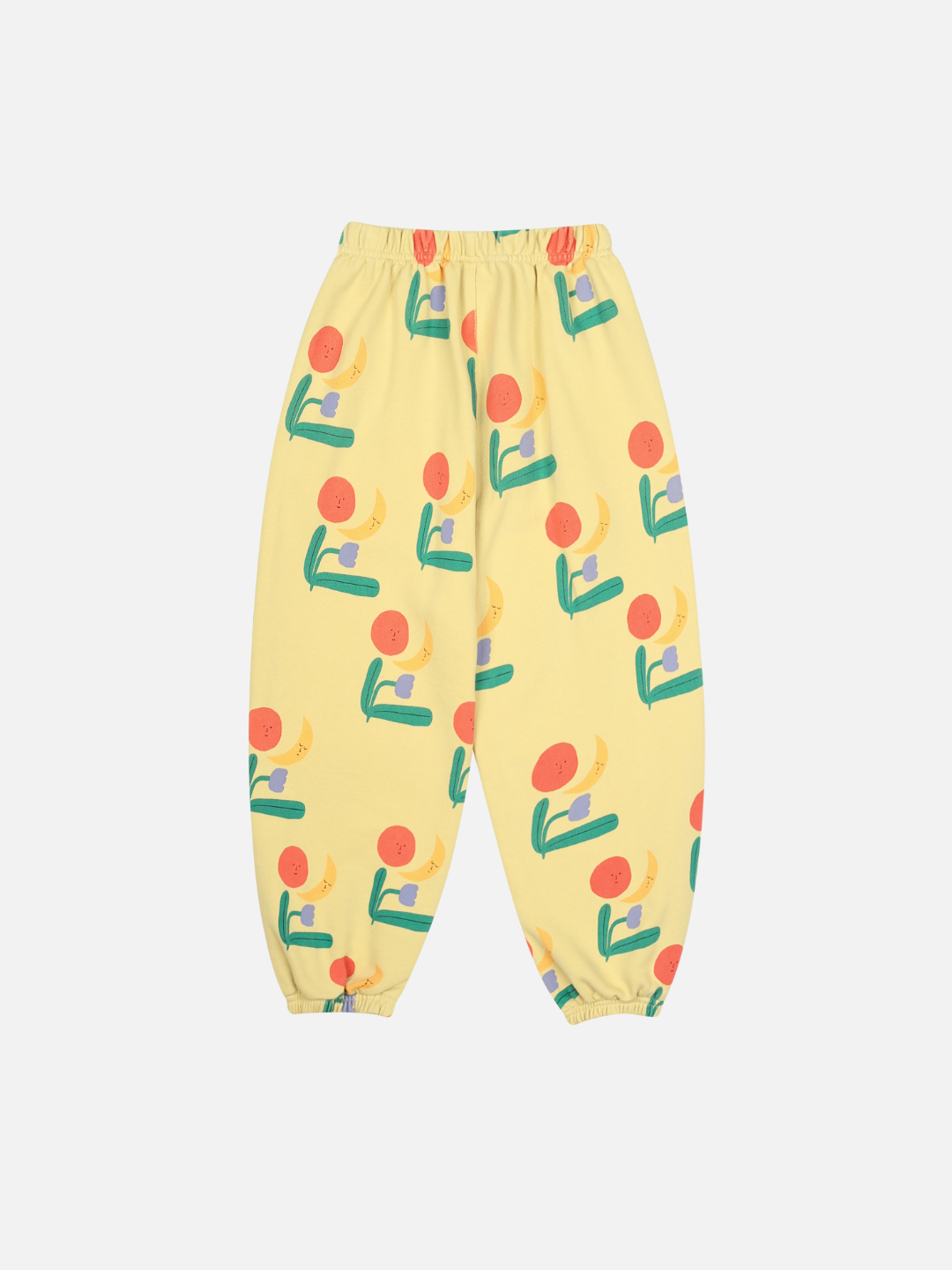 COLORED NATURE ALLADIN PANTS: Yellow pants with elastic waistband and cuffs, featuring a vibrant fruit and abstract pattern in red, green, and blue—perfect for a bold, colorful style.