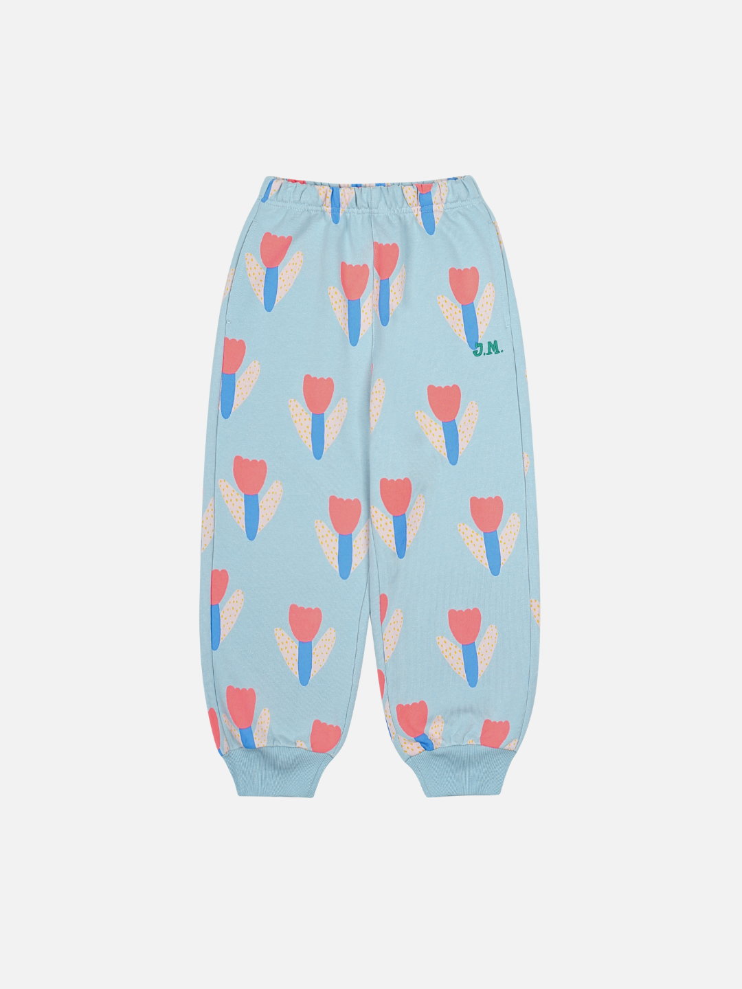 TULIP SWEATPANTS: Light blue children’s pants with elastic waistband and cuffs, decorated with orange, blue, and beige tulip flowers and a small green "B.M." logo. Playful design combines comfort, style, and value for your little one.