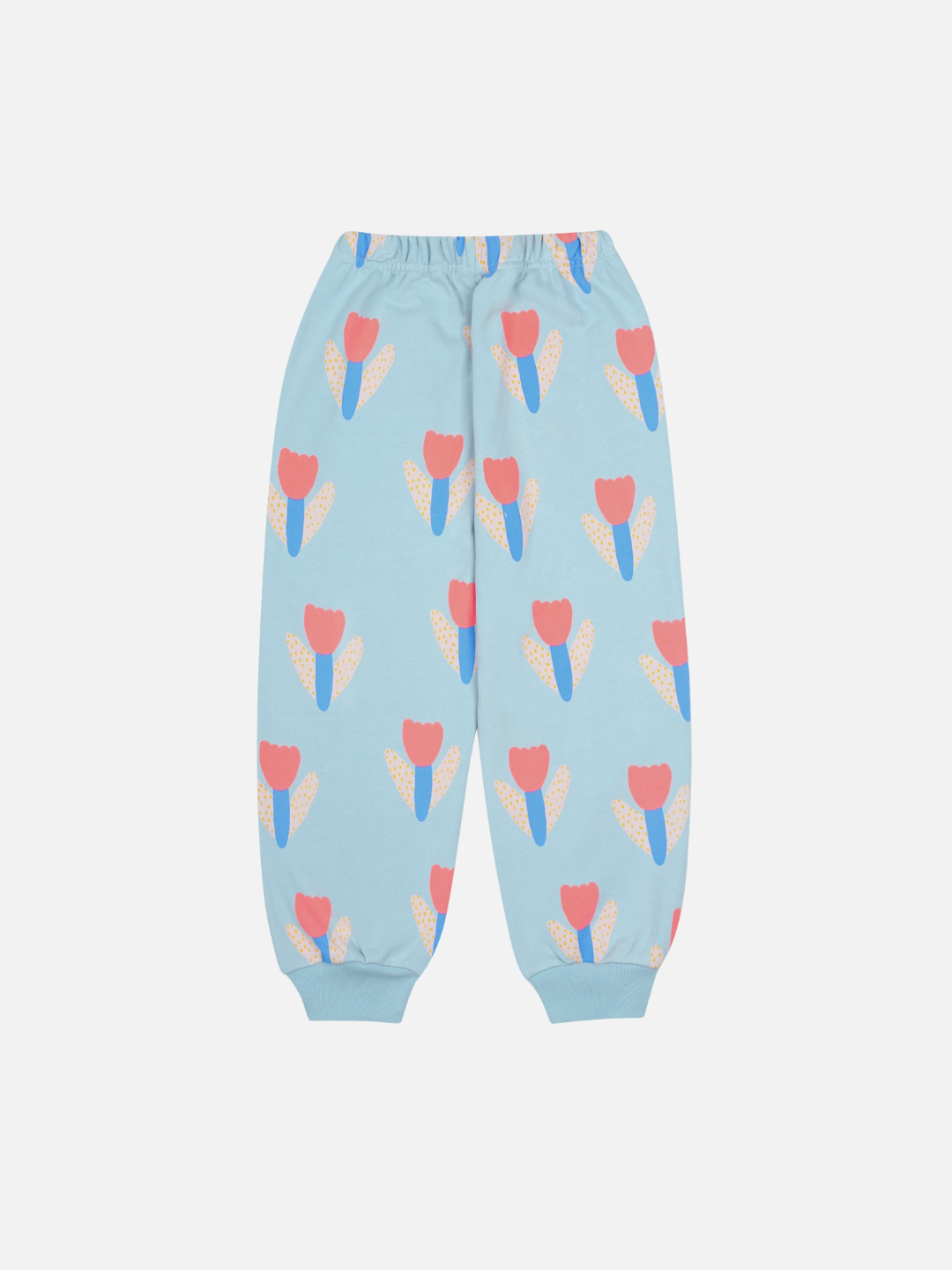 TULIP SWEATPANTS: Light blue children’s pants with an elastic waistband and cuffs, featuring a red and orange tulip pattern—a stylish choice.