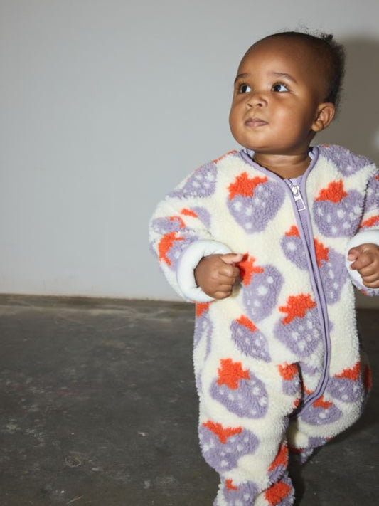 Second image of Cream-colored STRAWBERRY SHERPA FLEECE STROLLER SUIT for infants with a purple strawberry print and a front zipper.