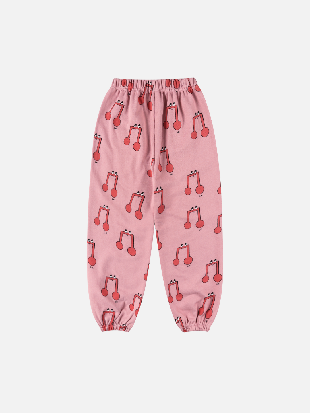 The MELODY ALADDIN PANTS are pink with an elastic waist and cuffs, adorned with a repeating red cherry pattern