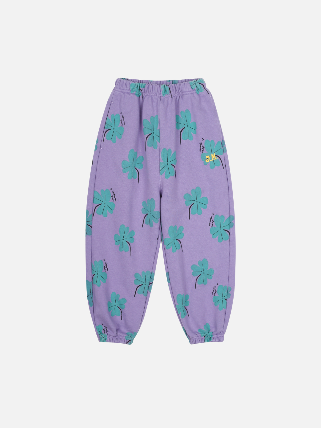 LUCKY CLOVER ALADDIN PANTS: Purple sweatpants with an elastic waistband and cuffs, adorned with a green shamrock print and a small bee on the upper right leg