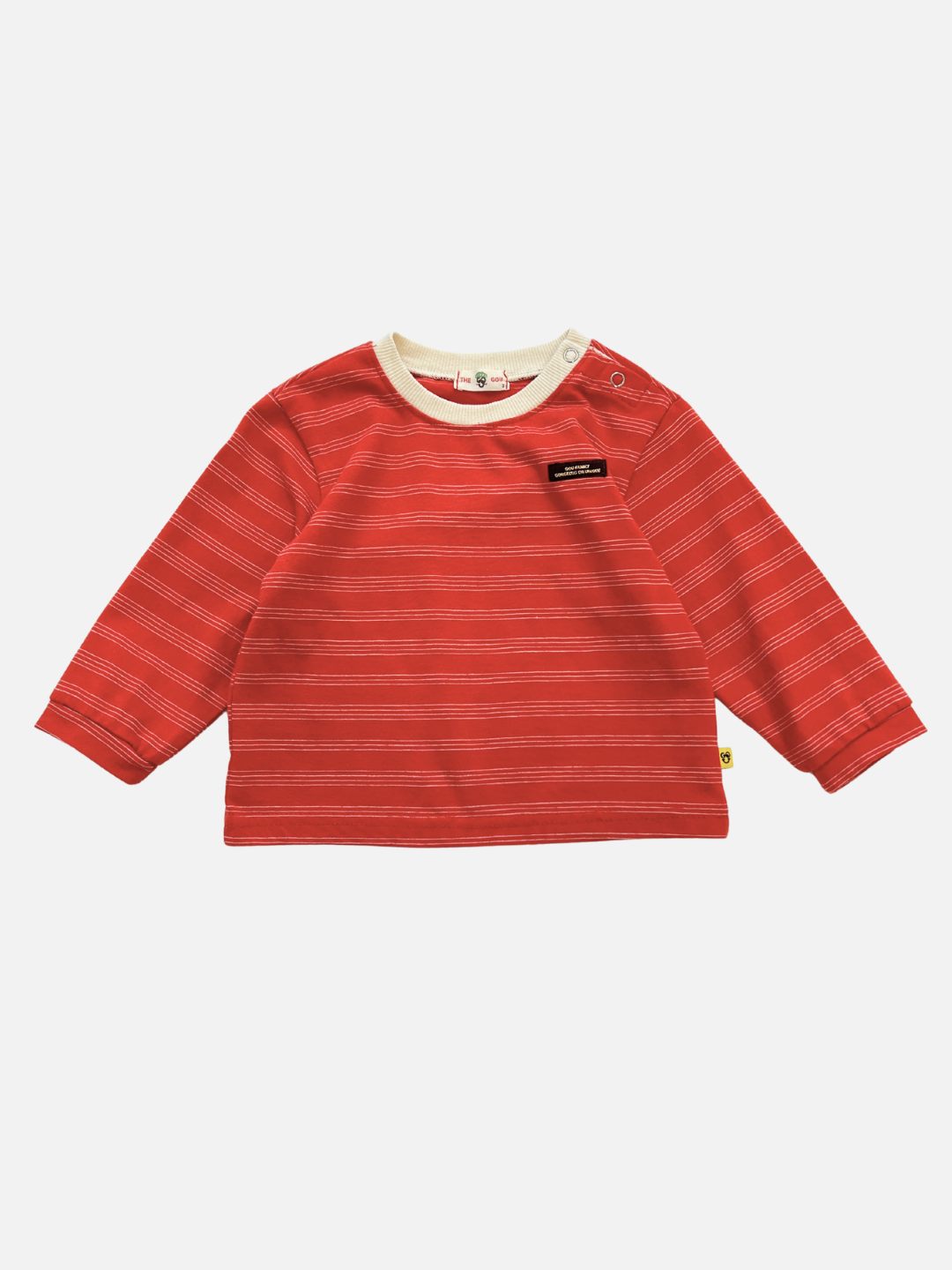 The MINI STRIPE LONGSLEEVE is a red, long-sleeved baby tee with white stripes, round collar, and snap buttons on the left shoulder. Made from soft cotton and inspired by Korean baby clothing. Displayed on a white background.