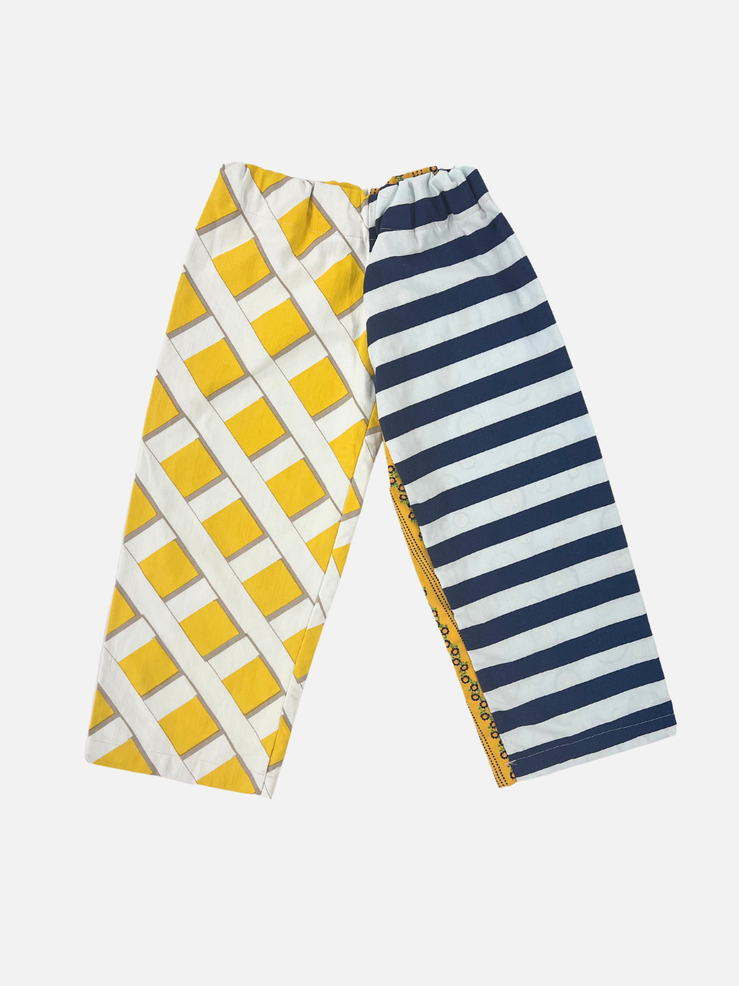 Front view of kid's patchwork pant. Left leg - fence resembling yellow print. Right Leg - navy stripe.