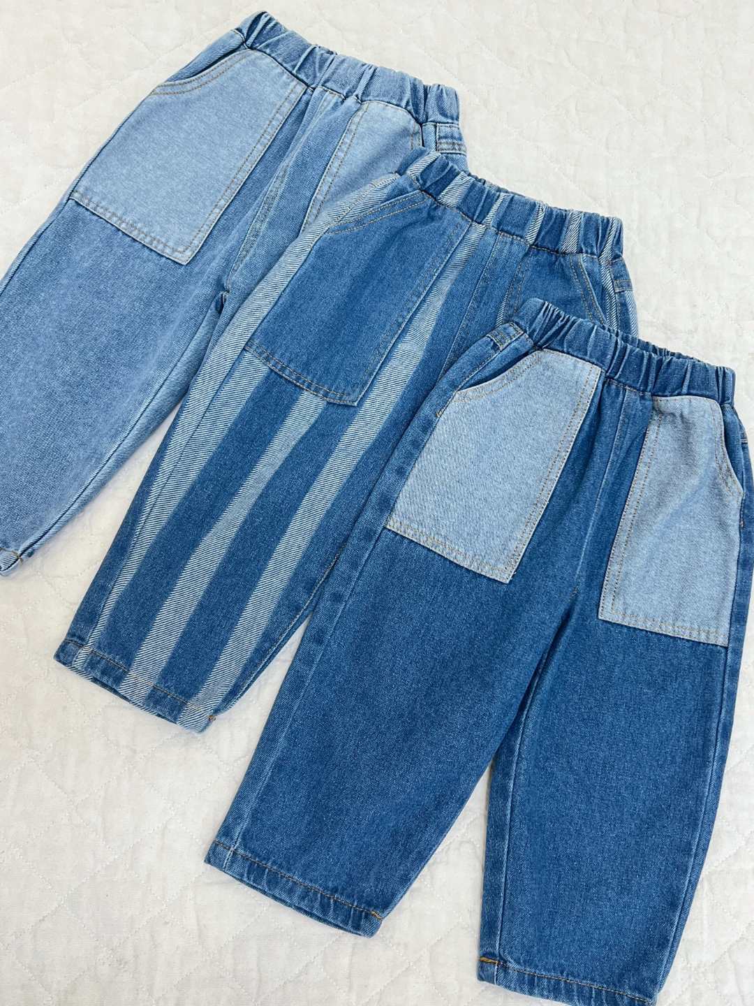 Dark Wash | Double Trouble Jeans in Medium Wash, dark Wass, and striped on a quilt