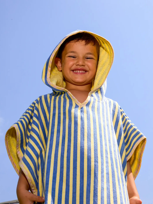 Second image of Yellow | The STRIPED PONCHO features vertical blue and yellow stripes and is OEKO-TEX certified. Shown flat on a white background, this kids bath poncho offers comfort and vibrant style.