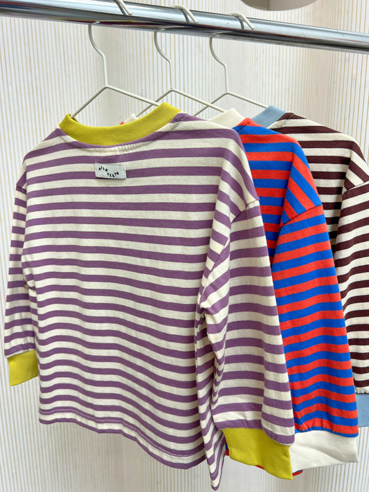 Second image of Purple/Ecru | STRIPE LONGSLEEVE crafted from 100% cotton jersey in a relaxed fit, showcasing purple and white stripes with contrasting yellow collar and cuffs, shown against a plain white background.