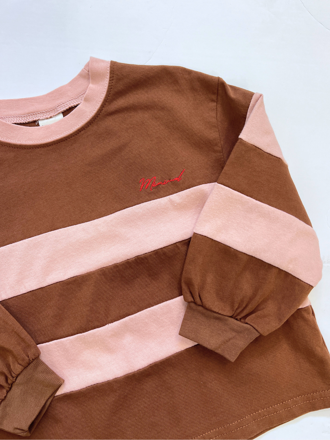 The RINGER LONGSLEEVE is a boxy medium-weight cotton tee with wide brown and pink stripes, featuring "Mood" embroidered in red on the chest—a perfect Minimal brand statement.