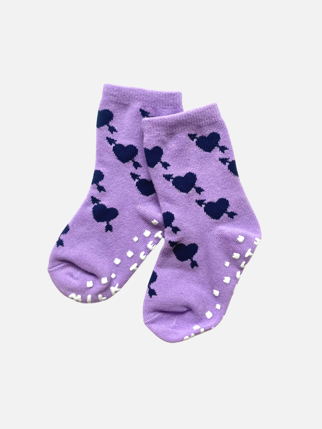 Violet Lovestruck | A pair of GRIP SOCKs in Violet Lovestruck with dark blue heart patterns and plush white anti-skid grips on the soles.