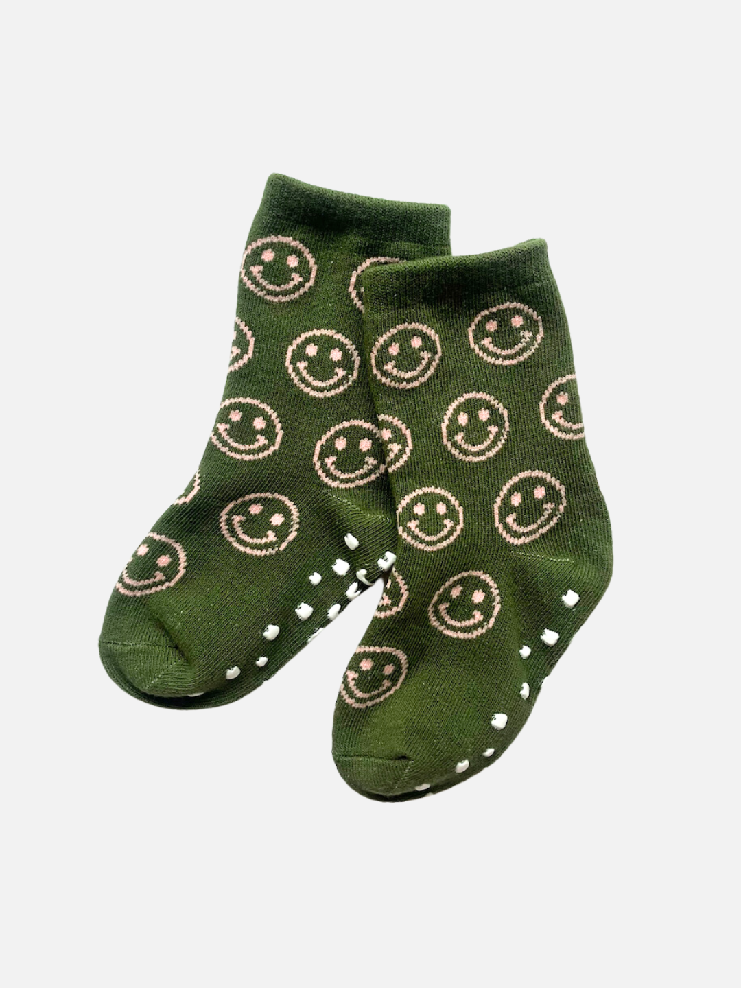 Olive Smile | An olive "GRIP SOCK" for children featuring beige smiley face patterns, made from stretchy fabric with plush anti-skid grips on the bottom.
