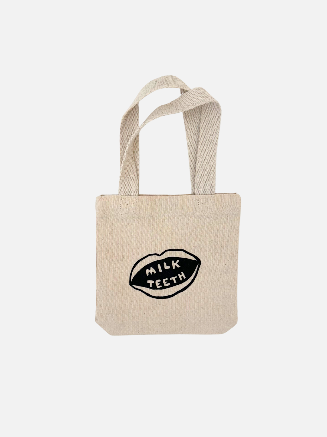 Milk Teeth mini tote front view. Cotton tote with Milk Teeth mouth logo in the center.