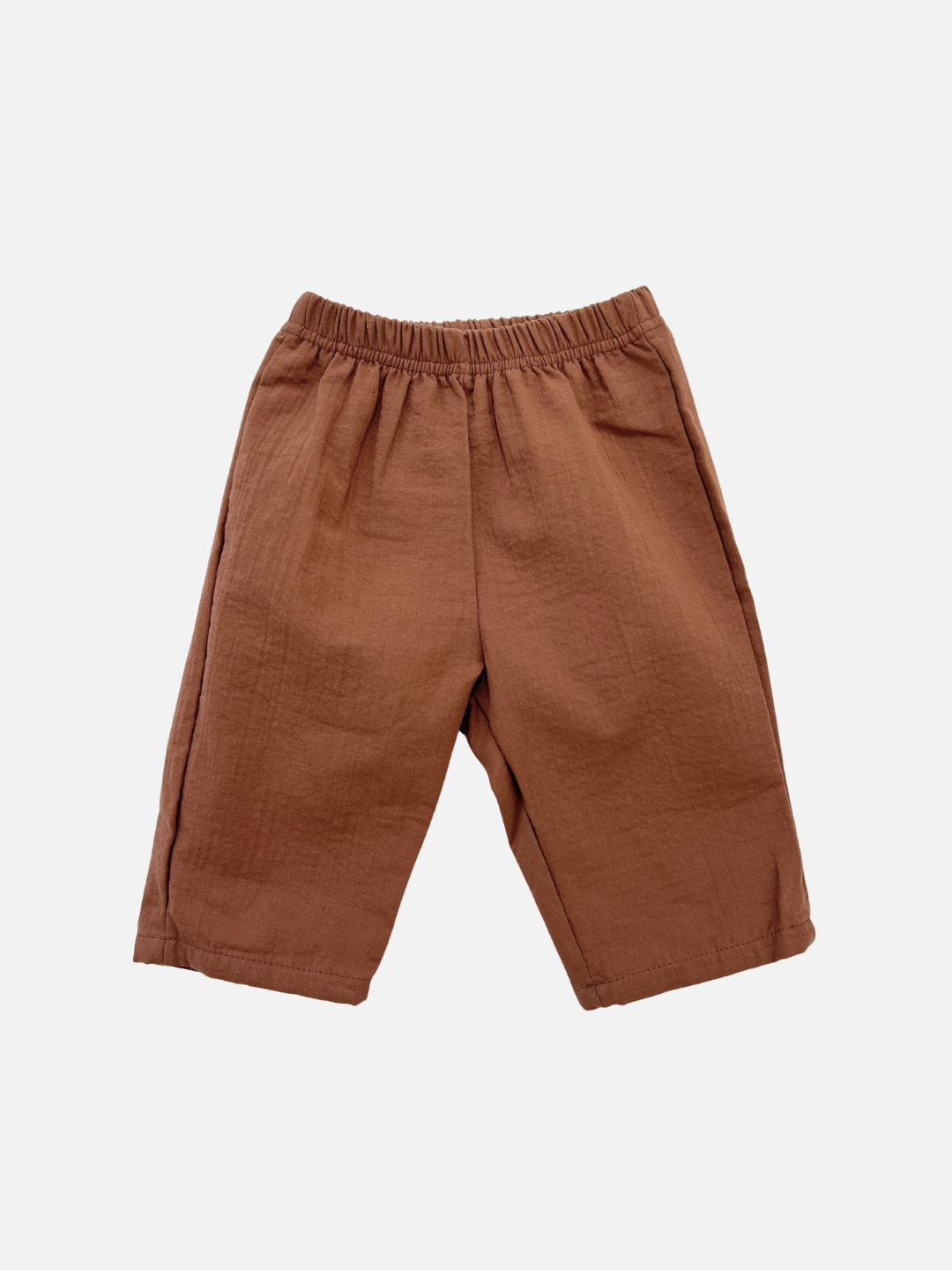 The CLOUD COTTON PANT is a pair of brown, relaxed-fit pants crafted from breathable woven cotton with an elastic waistband, shown against a plain white background.