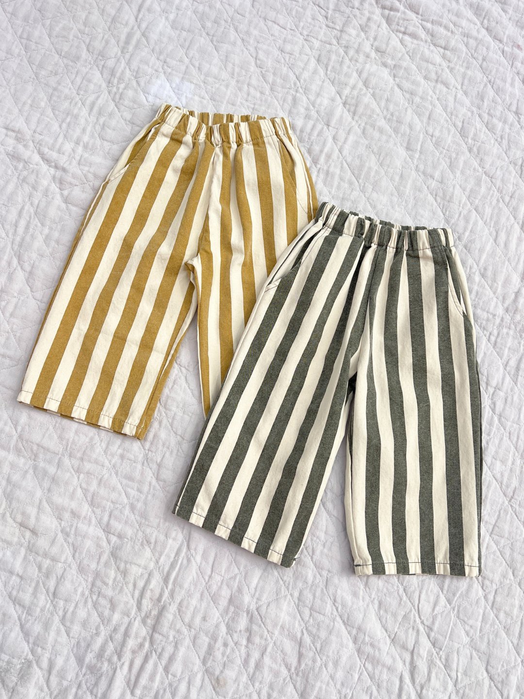 Two stripe pant on a quilt