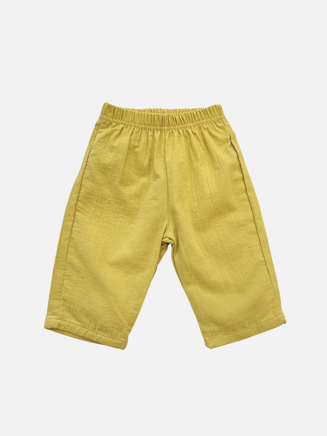 The CLOUD COTTON PANT, shown flat on a white background, features yellow breathable woven cotton and an elastic waistband for a relaxed fit and all-day comfort.