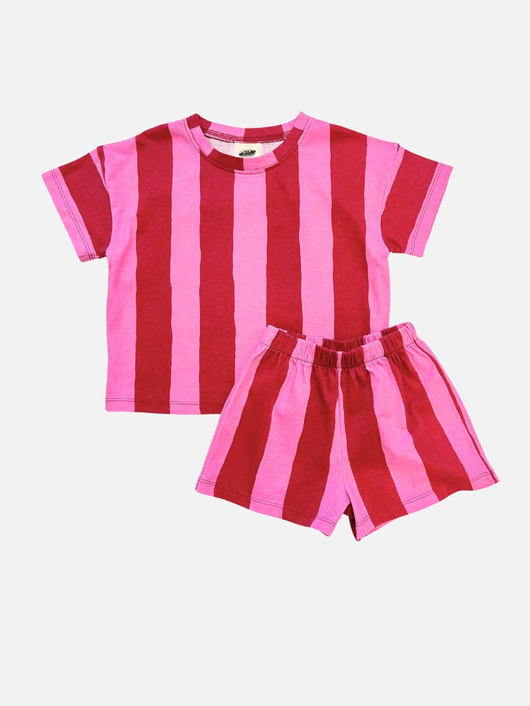 The UMBRELLA STRIPE SHORT SET in pink/red features a short-sleeve t-shirt and matching shorts, made from soft organic cotton and shown on a white background.