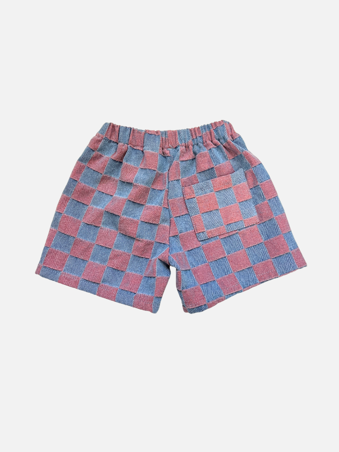Pink | The TWO TONE DENIM CHECK SHORTS feature an elastic waistband, pink and blue checkerboard jacquard pattern, and a single back pocket—a playful piece from a popular Korean kids brand.