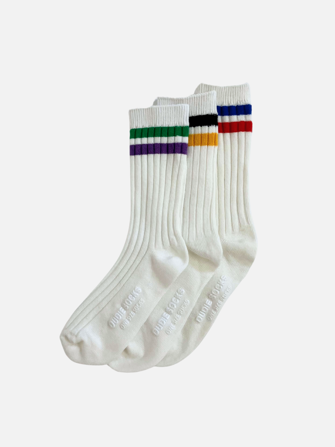 Three white ribbed kids socks with different color stripes at the top, lying in a angled row, overlapping.