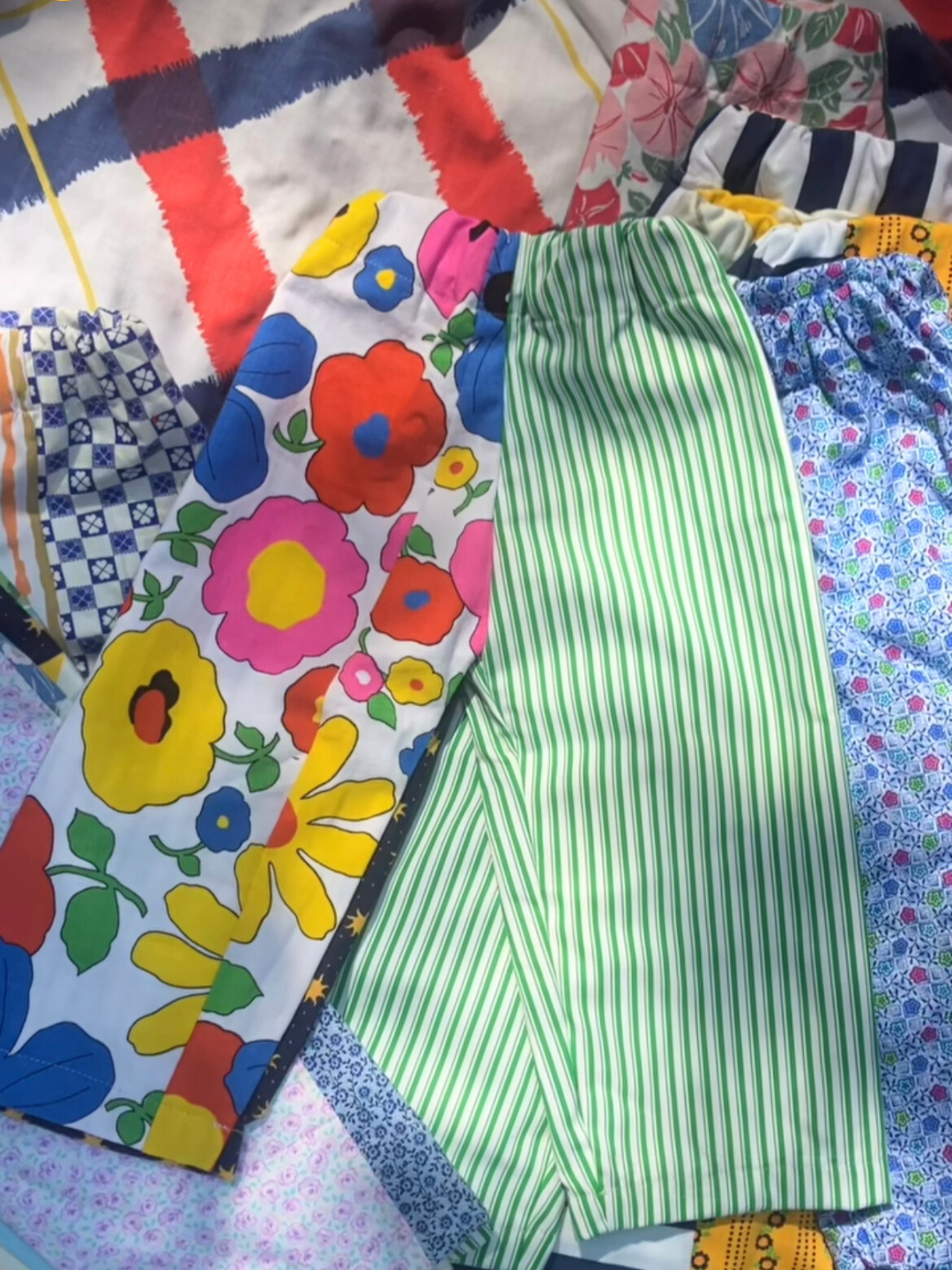 A selection of kids' patchwork pants with many colors and patterns