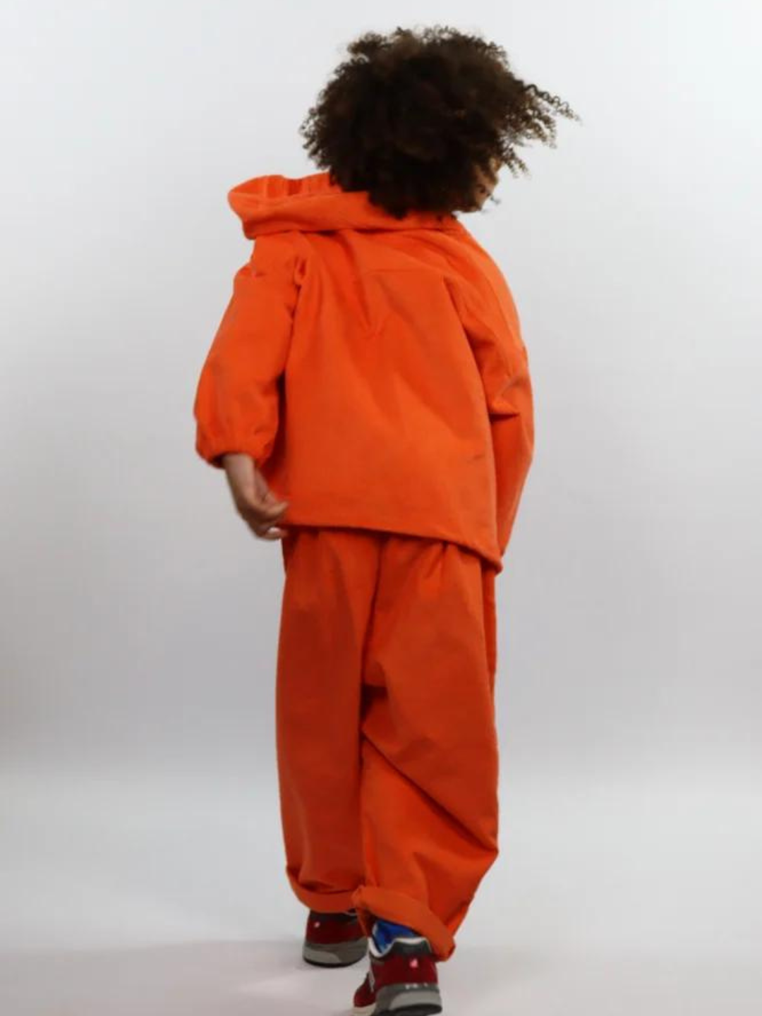 Orange | Child wearing orange kids' hooded smock and pants, back view